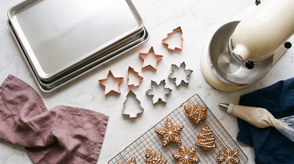 Holiday baking essentials: cookie sheets, stand mixer, cookie cutters, and cooling rack
